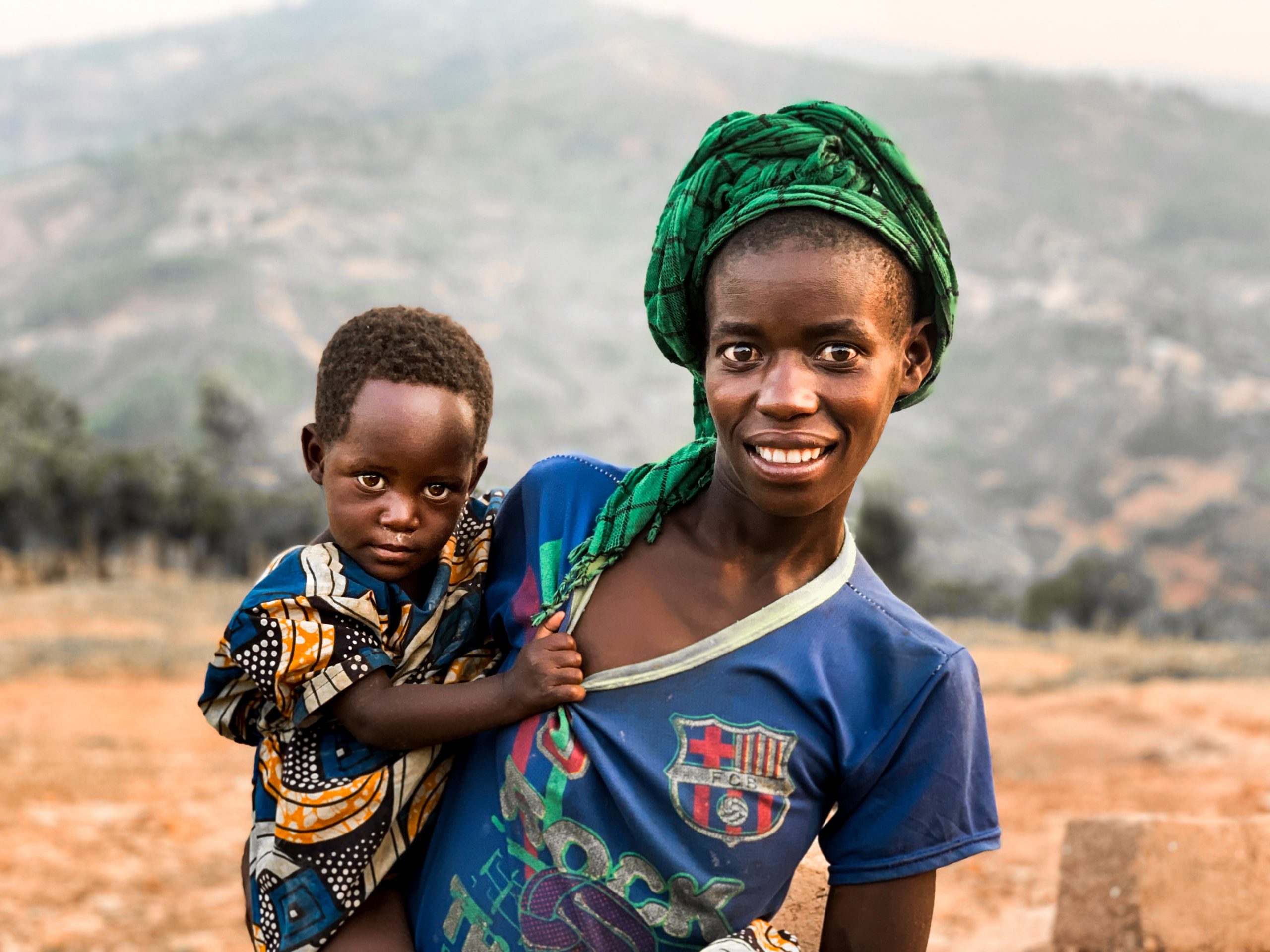 Rwandan woman holding baby on hip