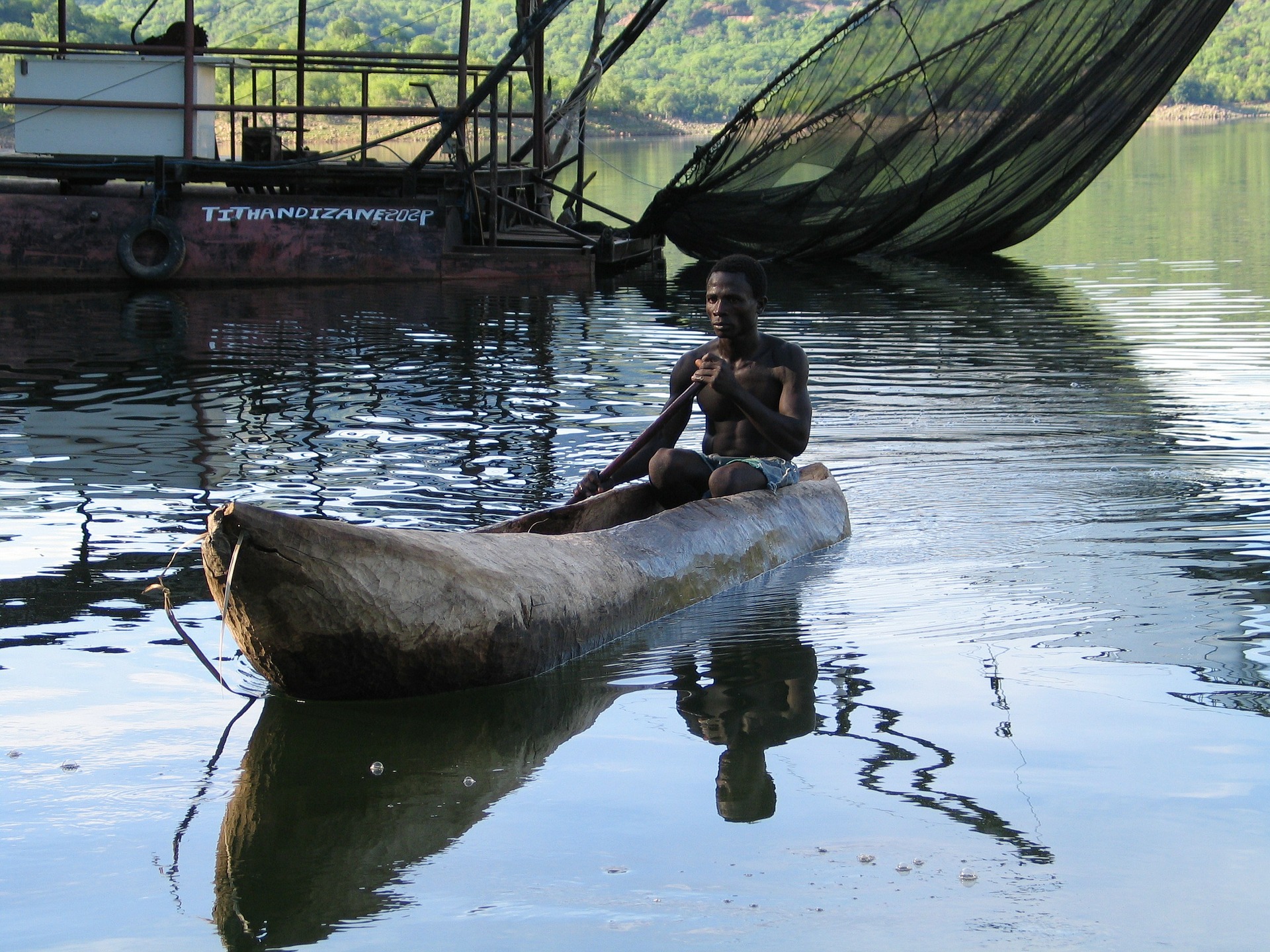 Person in a traditional dugout canoe in Mozambique