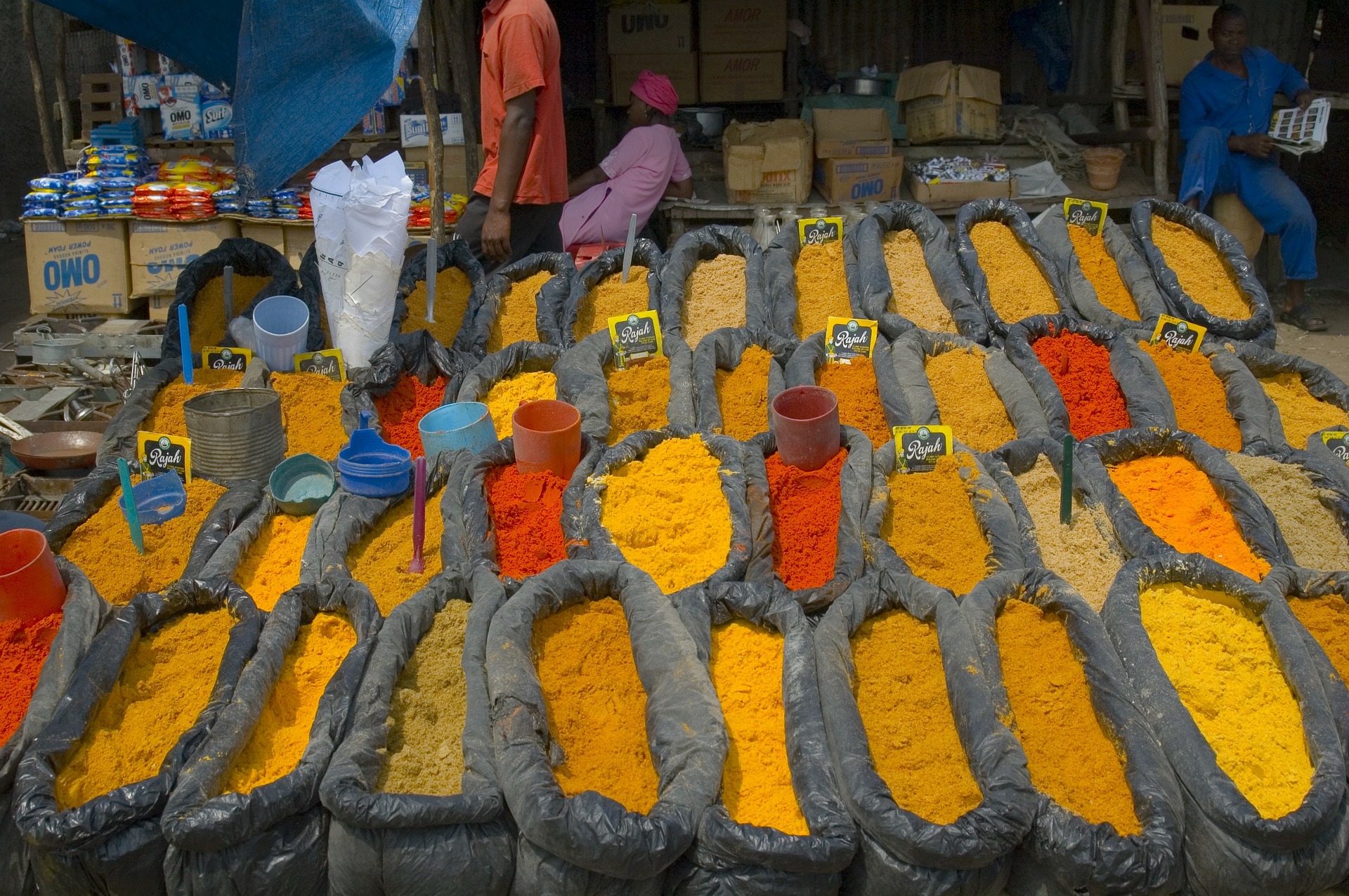 Array of colorful spices displayed in burlap bags at market in Mozambique
