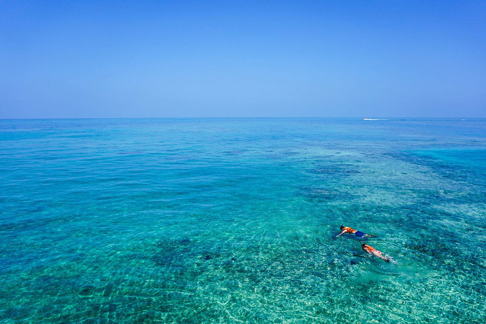 two people snorkeling in clear Blue waters Mozambique
