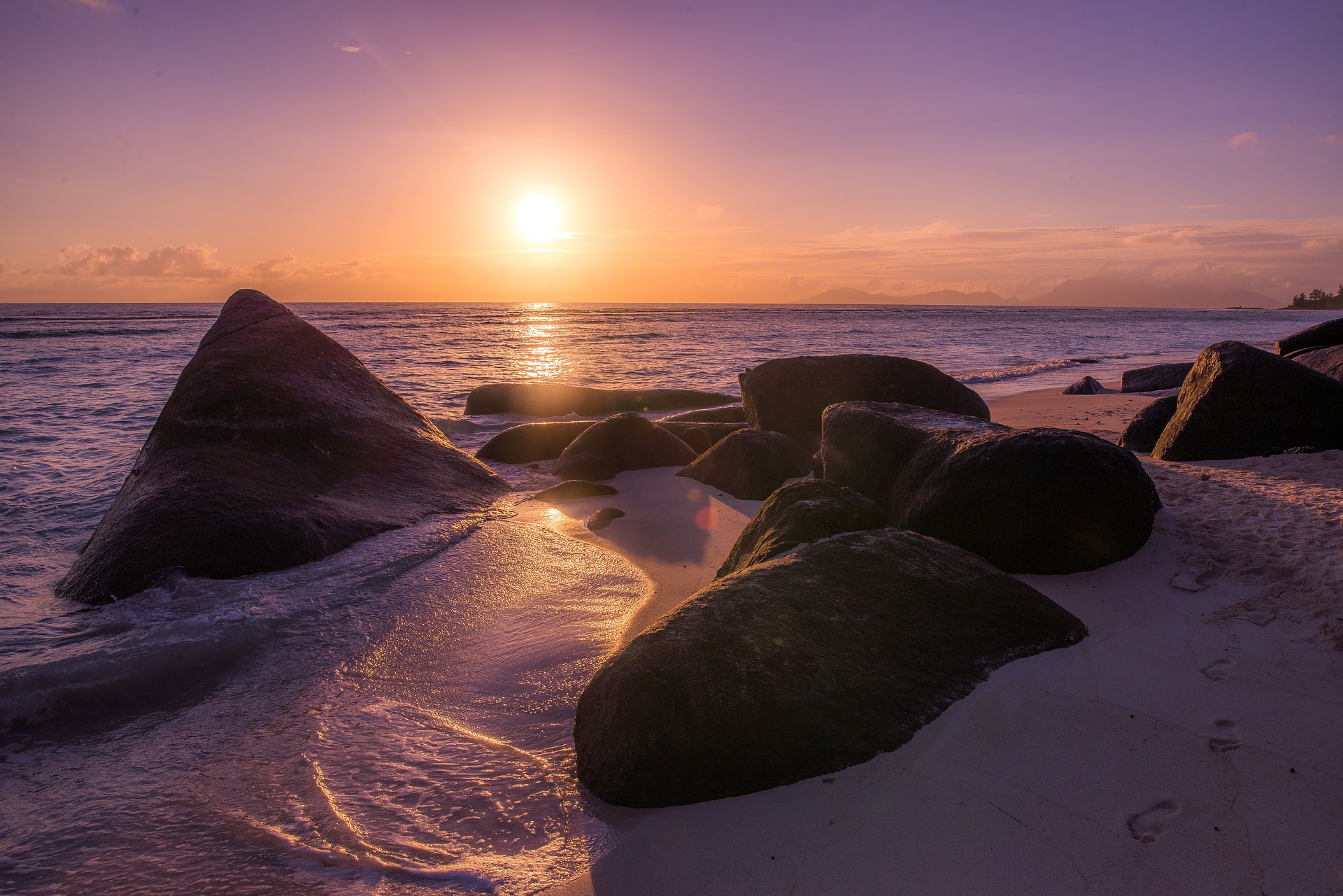 Sunrise over a rocky beach in the Seychelles