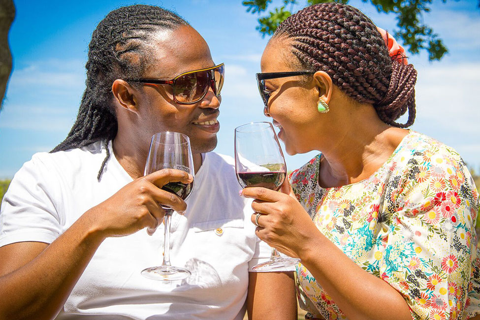 Two people enjoy drinking wine at a South African winery