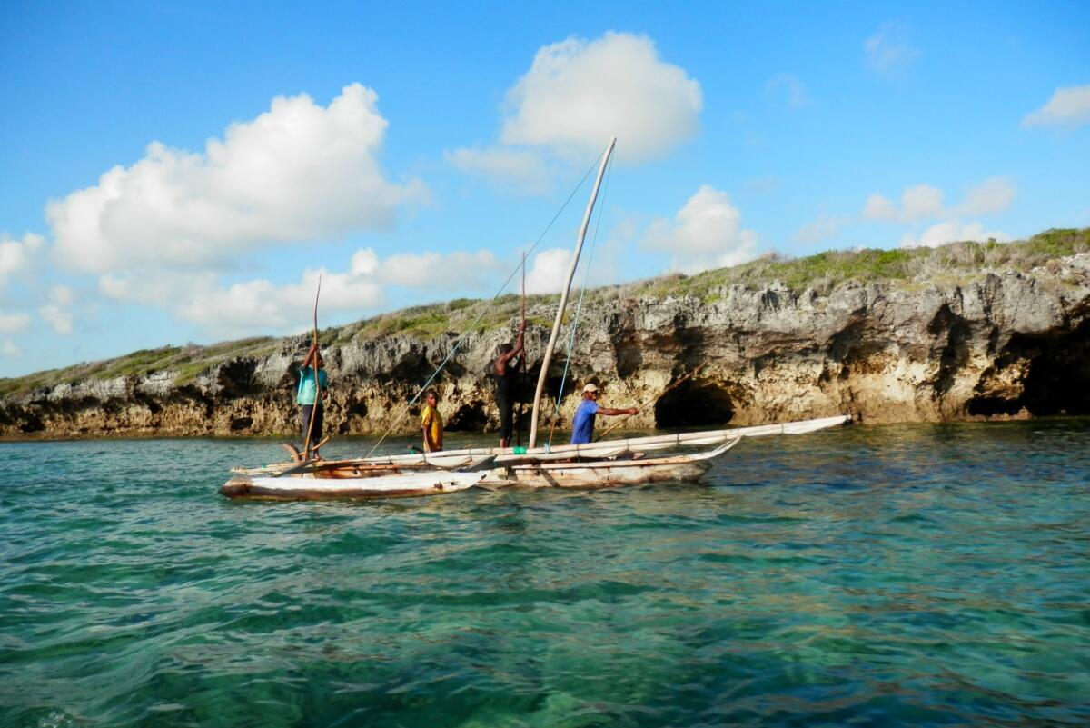 Traditional fishing boat floats on blue water near Zanzibar