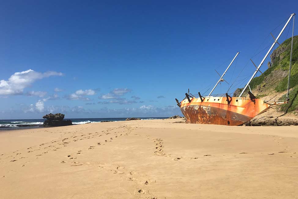 a sailboat washed up on shore at Machangulo Beach, Mozambique