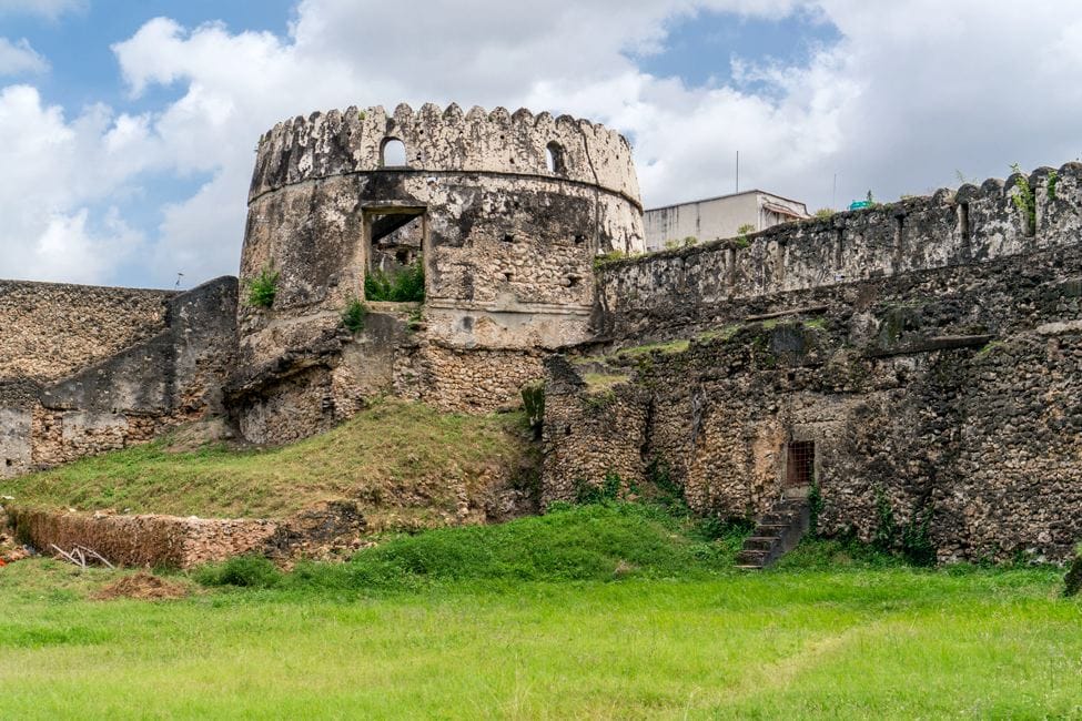 old stone fort with bright green lawn courtyard in Zanzibar
