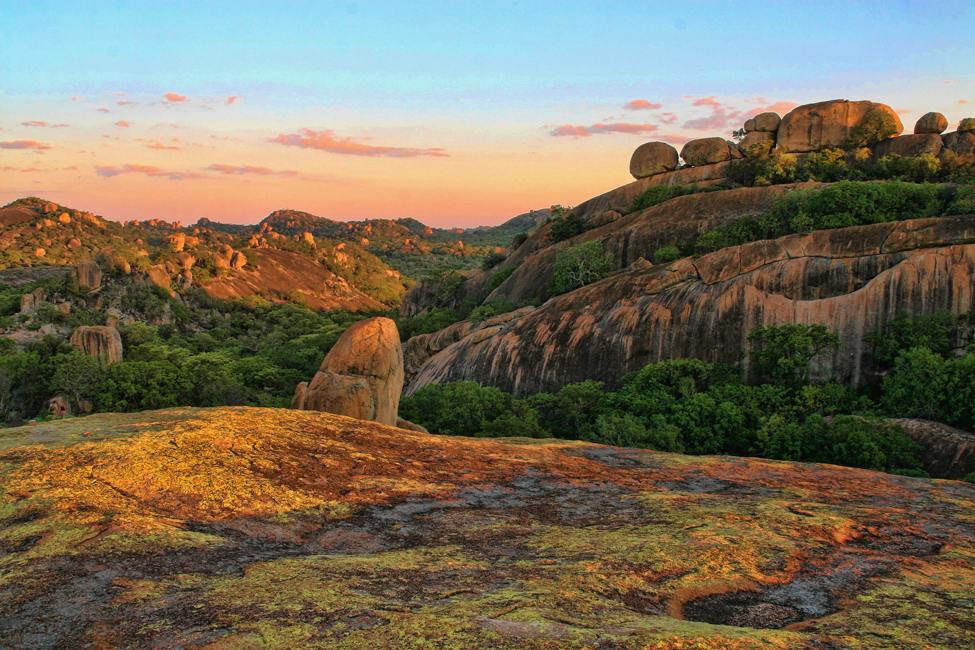 rounded granite rock formations with moss and bushes at Matopos National Park in Zimbabwe