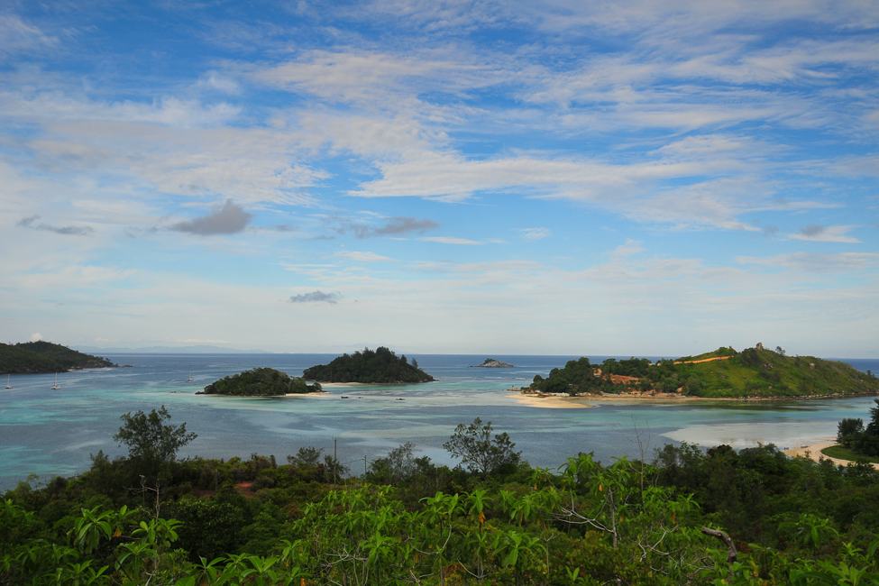view of several small forested islands in tropical Sainte Anne Marine National Park in Seychelles