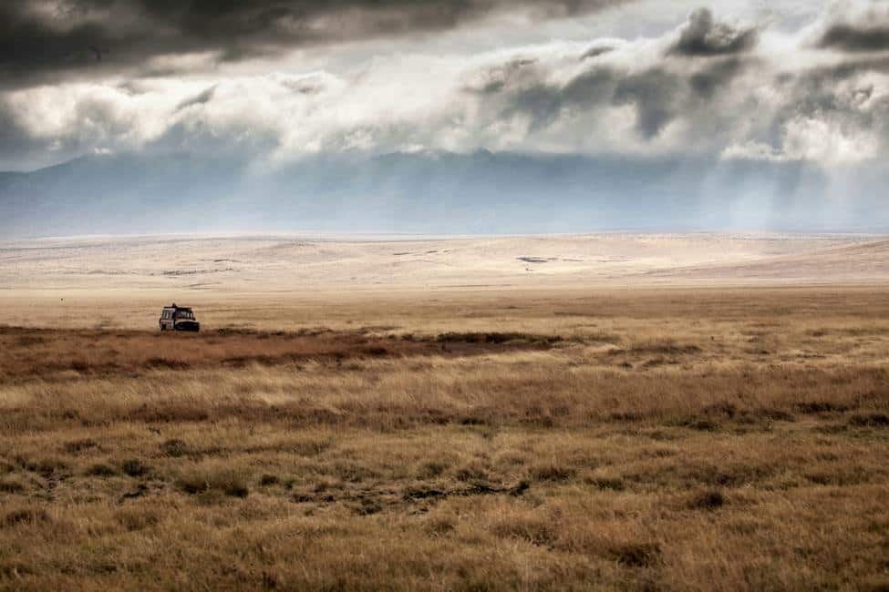 Game drive vehicle on Savannah at bottom of ngorongoro crater